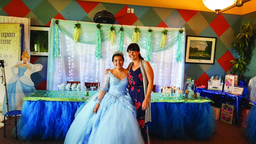 Salesgirl zips up teenage girl's party dress, little sister looks on Stock  Photo - Alamy