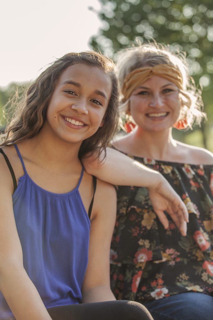 Big Brothers Big Sisters, young Little Sister with Big Sister, both smiling 